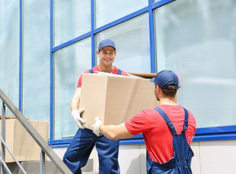 Personnel managing clean and organized storage unit areas safely