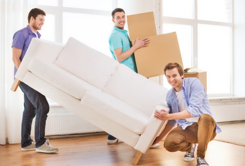 Family moving boxes into secure storage in East Finchley